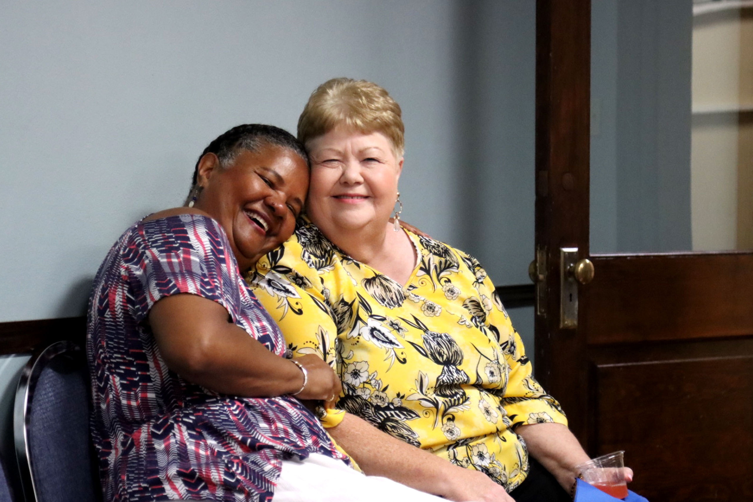 Sally Vonner embraces woman on a bench