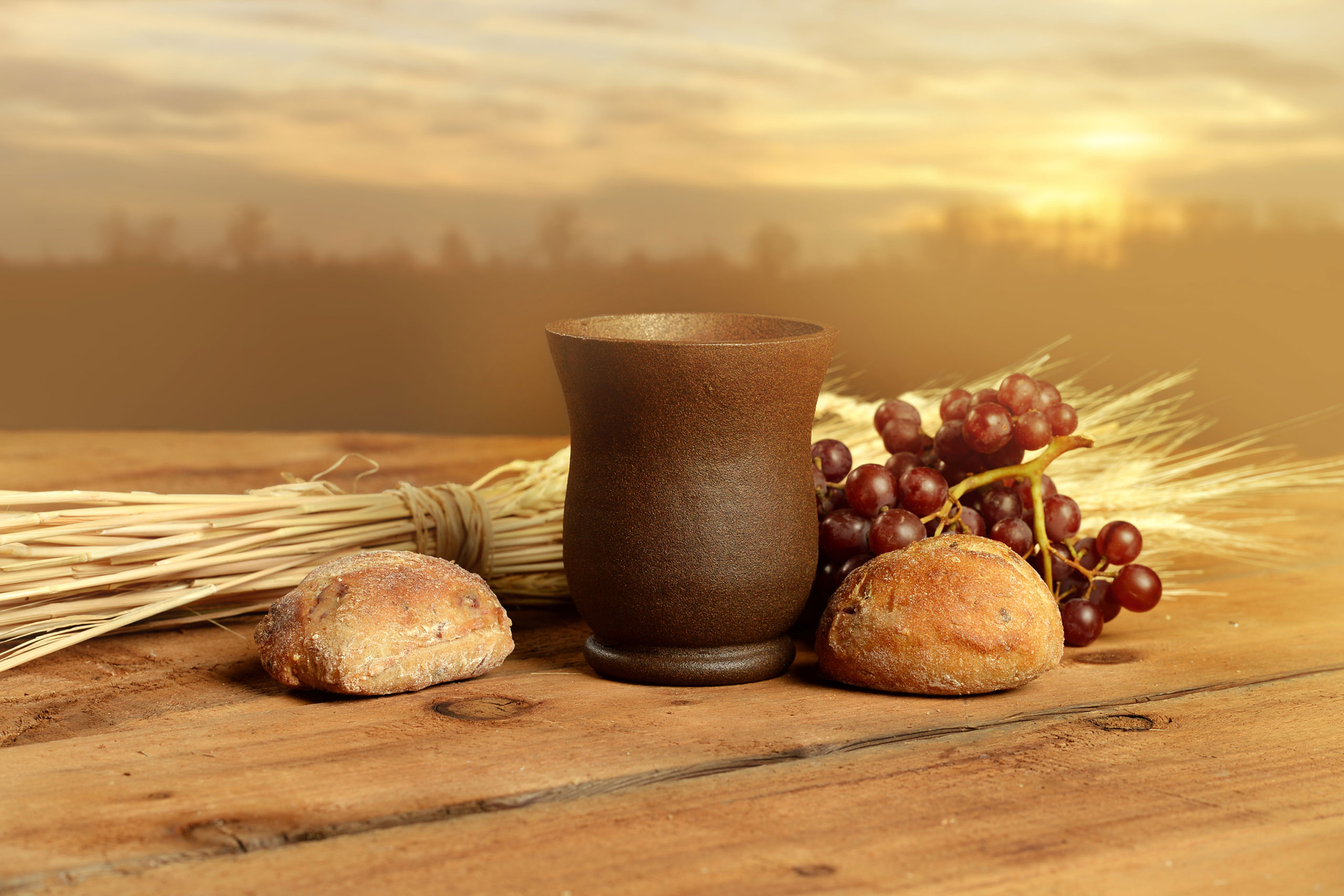 still life of wheat, bread, a cup, grapes