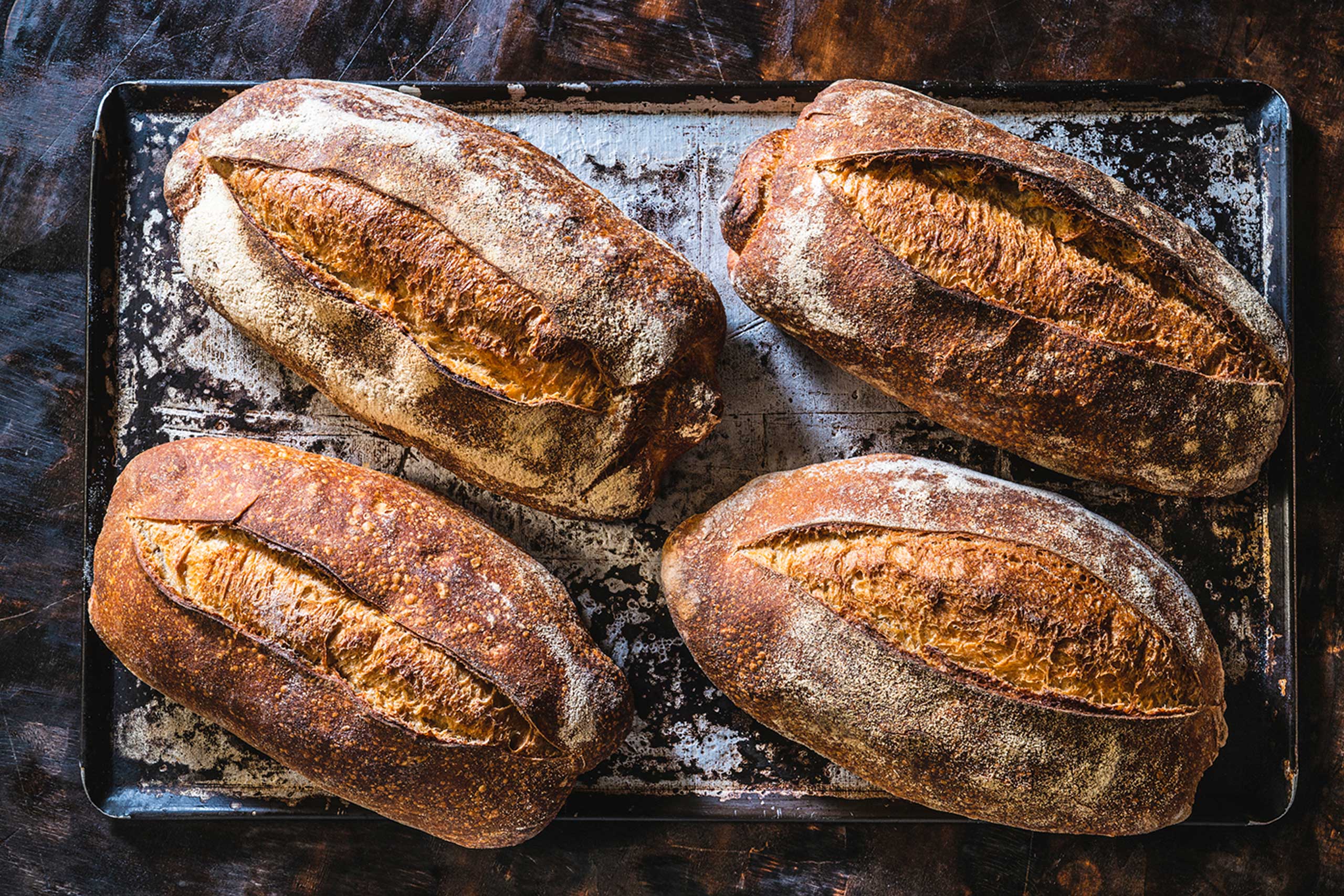 4 loaves of bread on a table