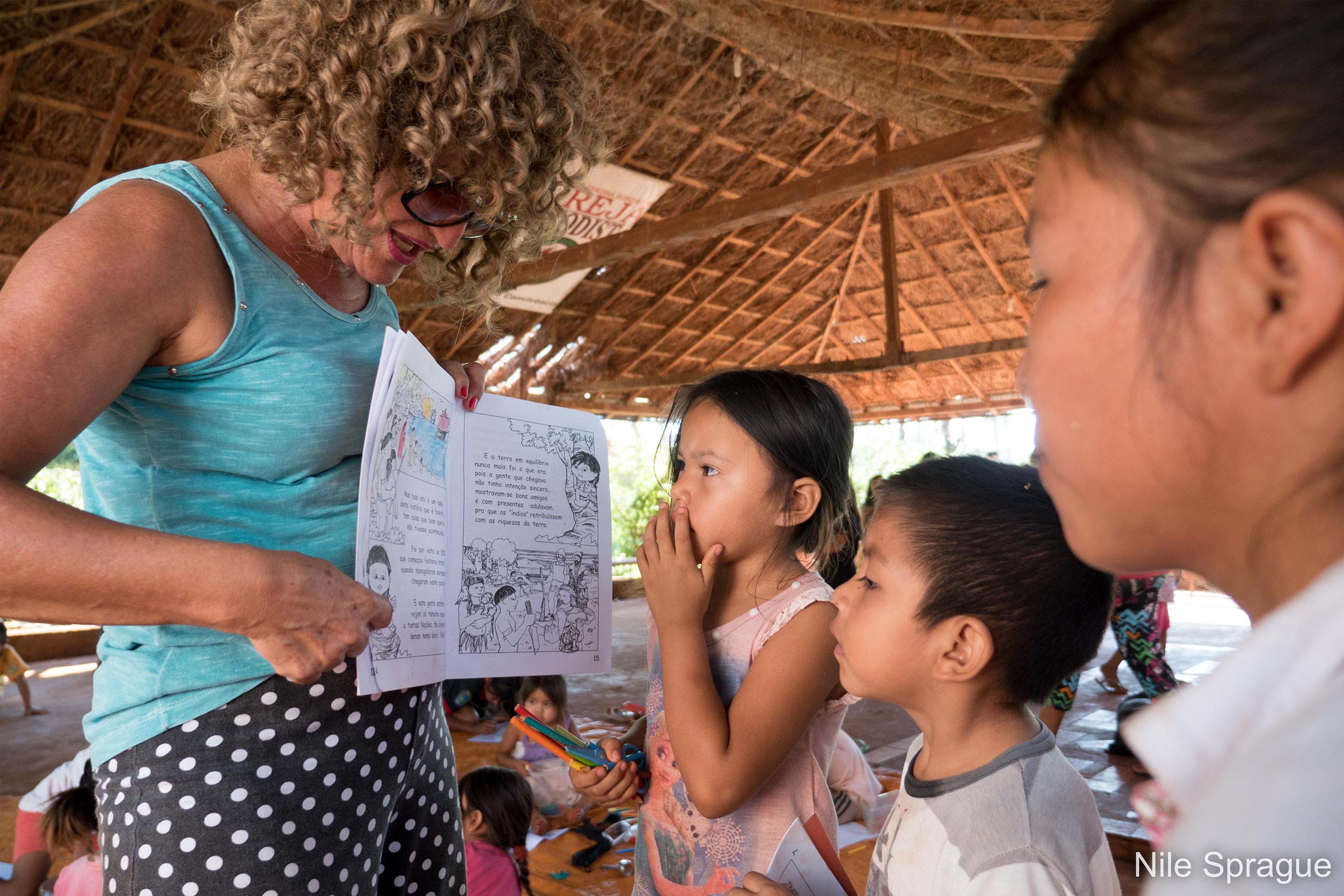 woman shows children picture book in Brazil