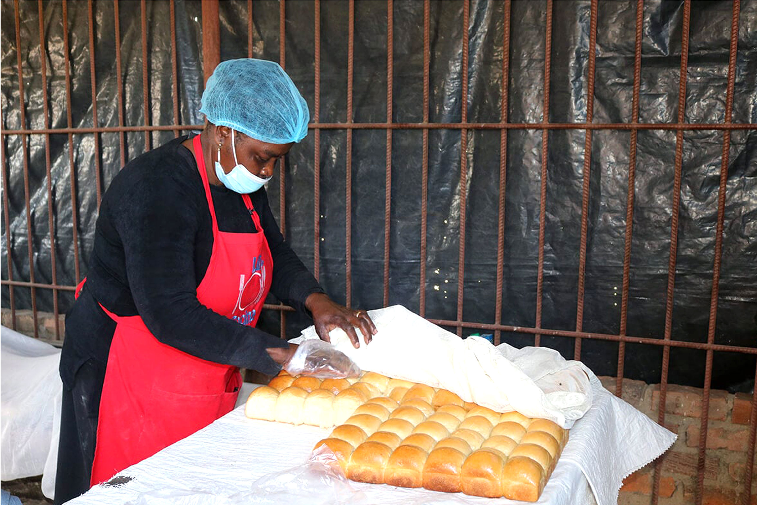 women tending to bread rolls in Zimbabwe